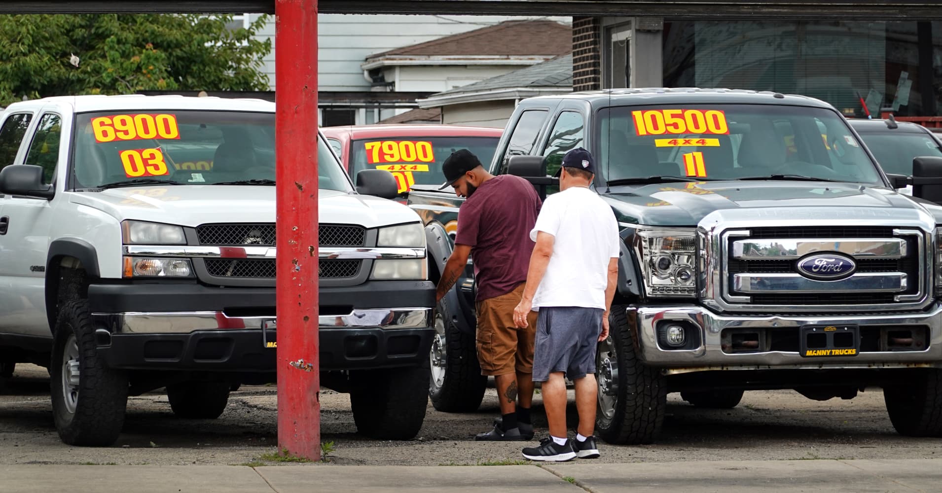 Used cars are offered for sale at a dealership on July 11, 2023 in Chicago, Illinois.