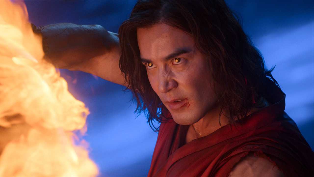 Ludi Lin's Liu Kang looking intensely while creating a flame from his hands in Mortal Kombat II