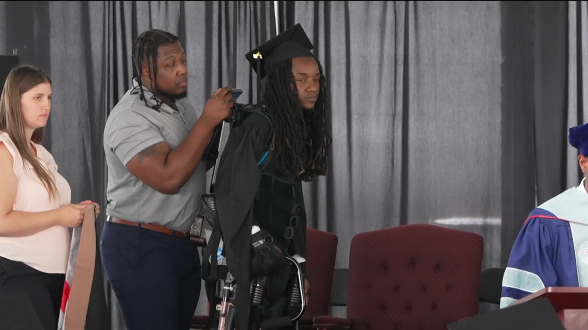 Paralyzed college grad walks across graduation stage