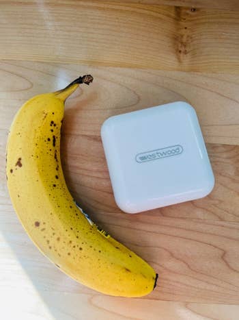 Author's photo of the pill case, closed and posed next to a banana for scale