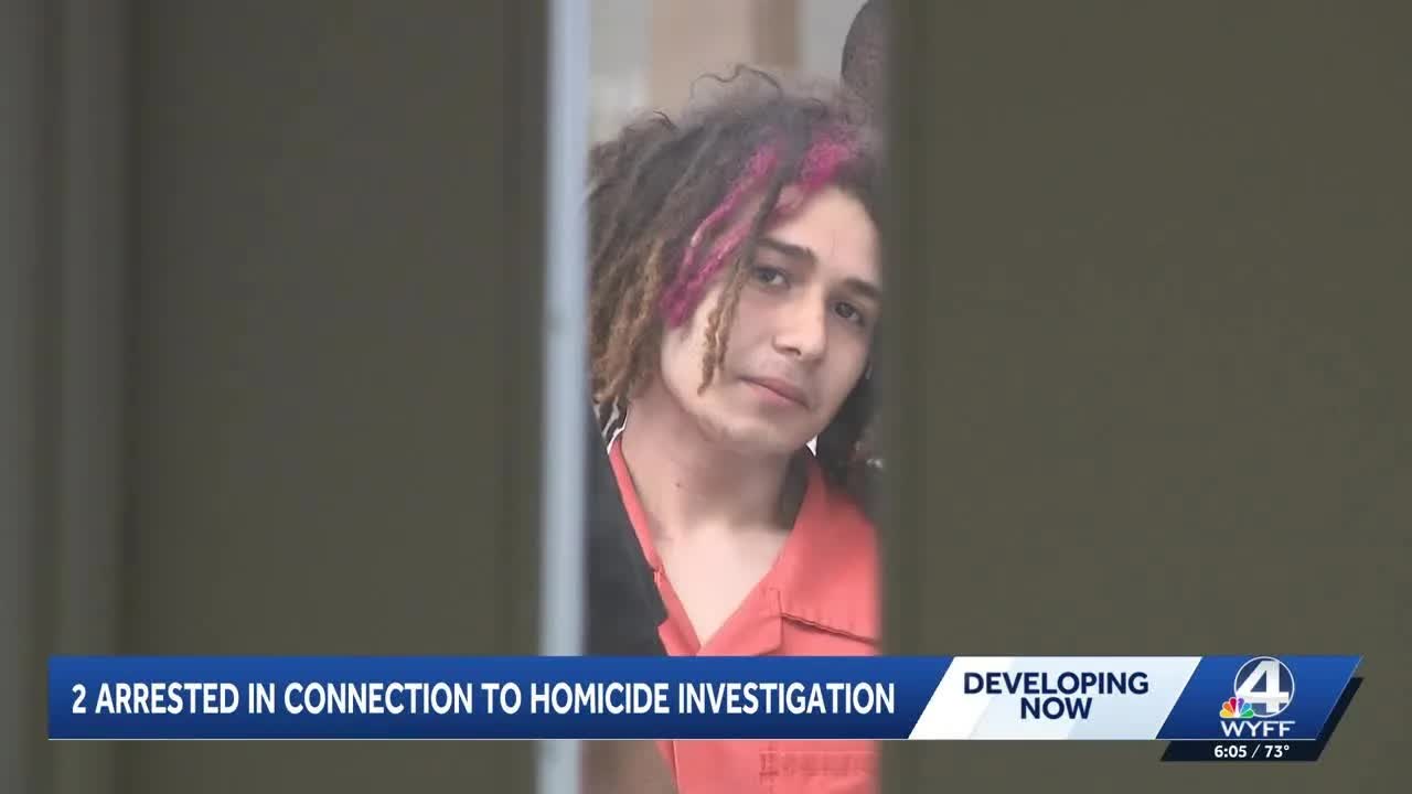 Two suspects charged after body found in burning car