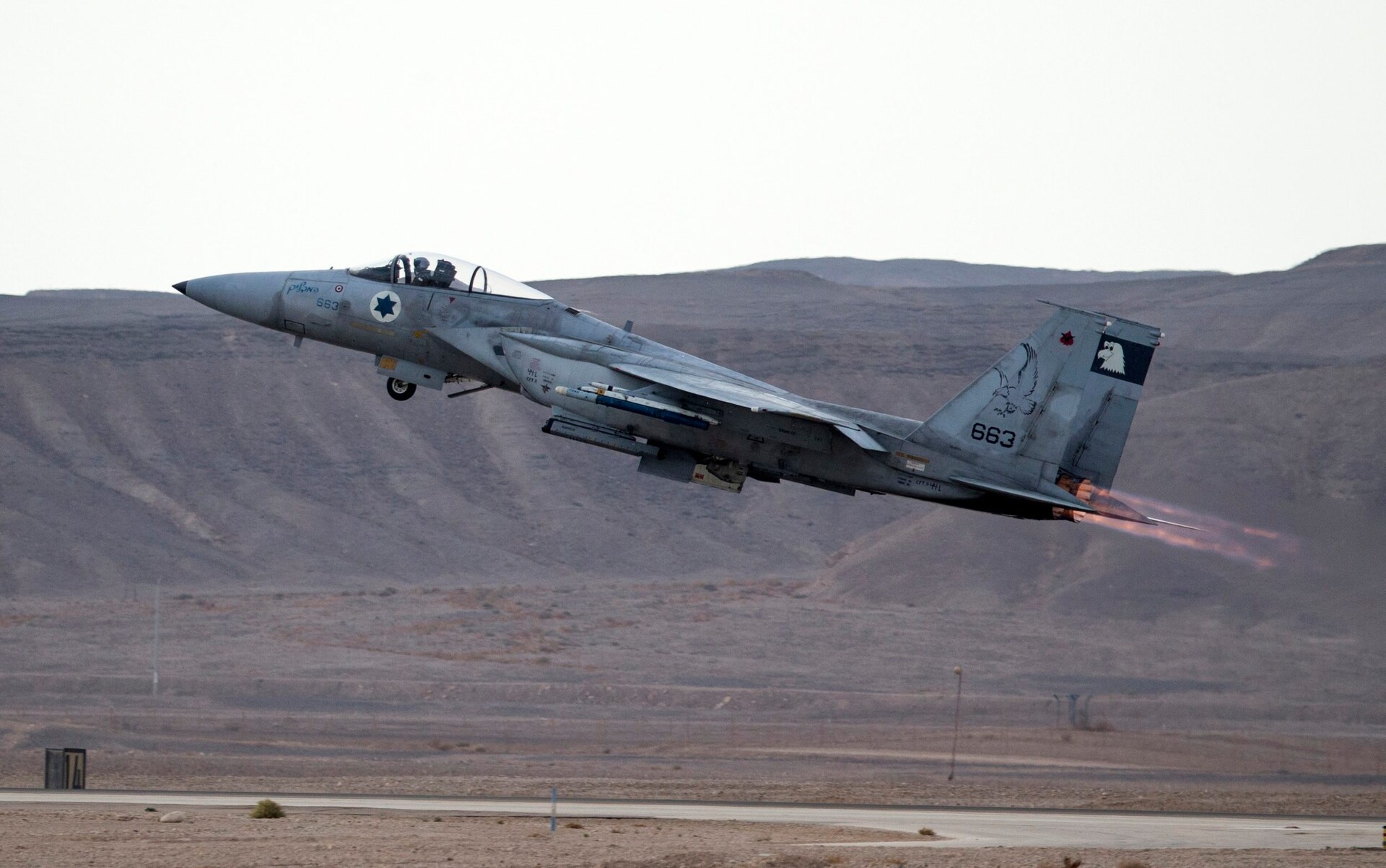 The jet is taking off in an arid landscape