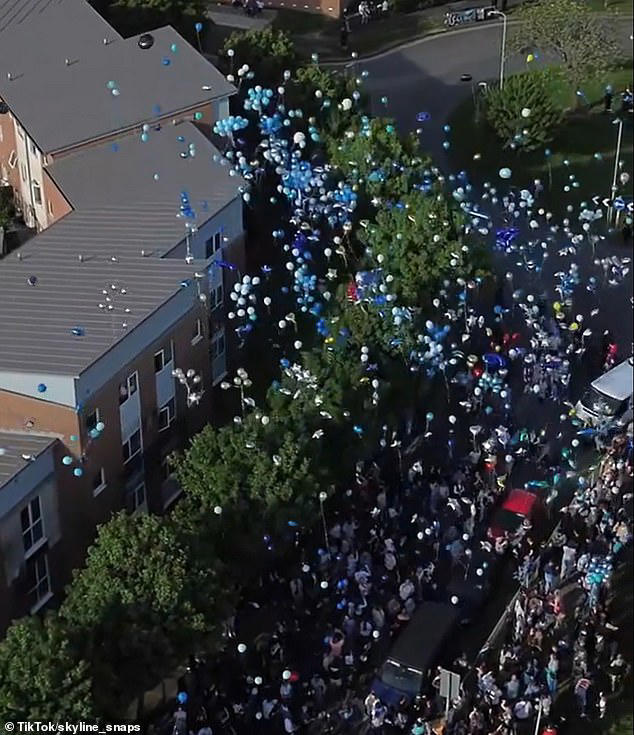 Hundreds of people gathered to release white and blue balloons and let off blue flares in memory of Jaydon and Ta-Shay
