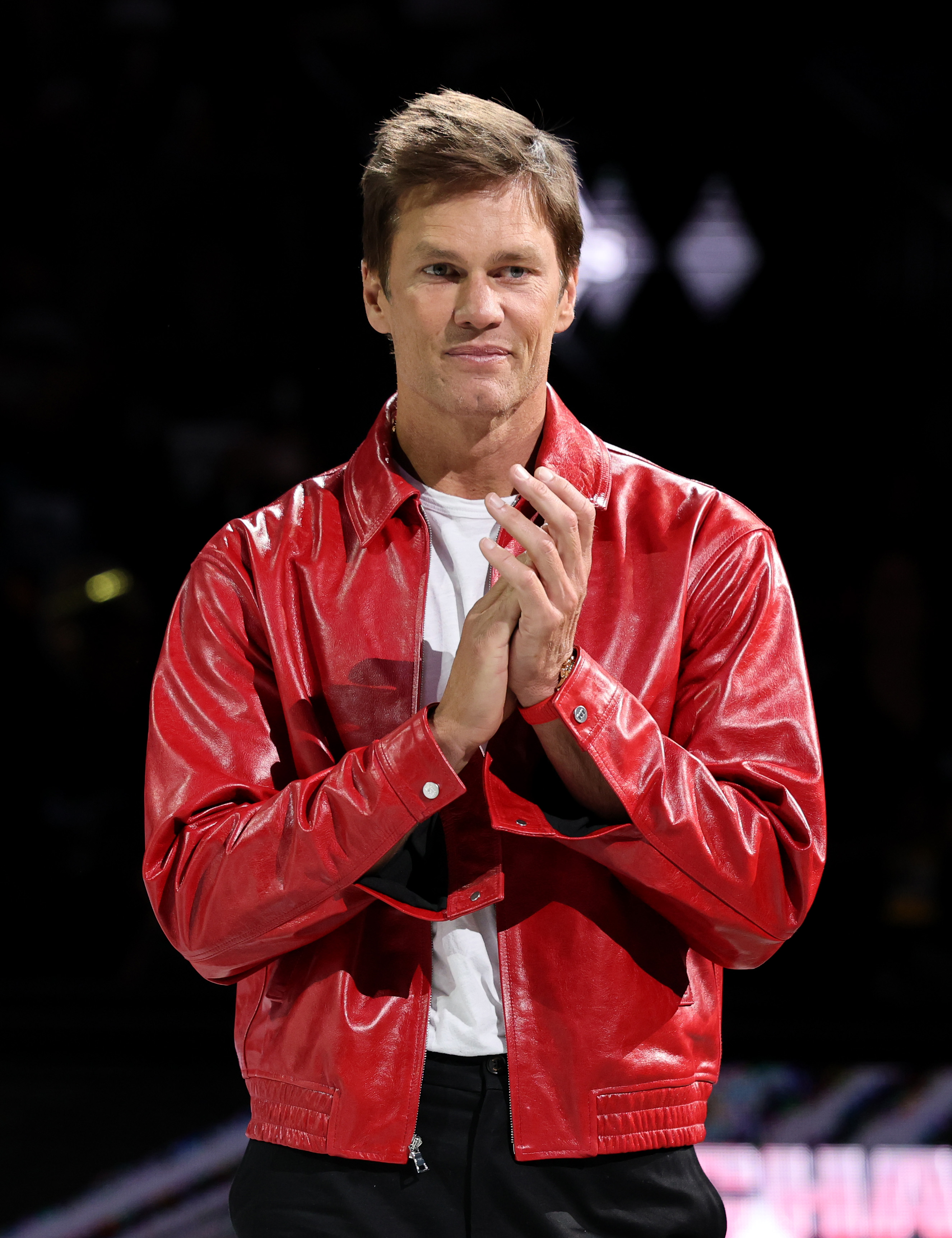 Tom Brady applauds during a 2025 championship ring ceremony for the Las Vegas Aces.