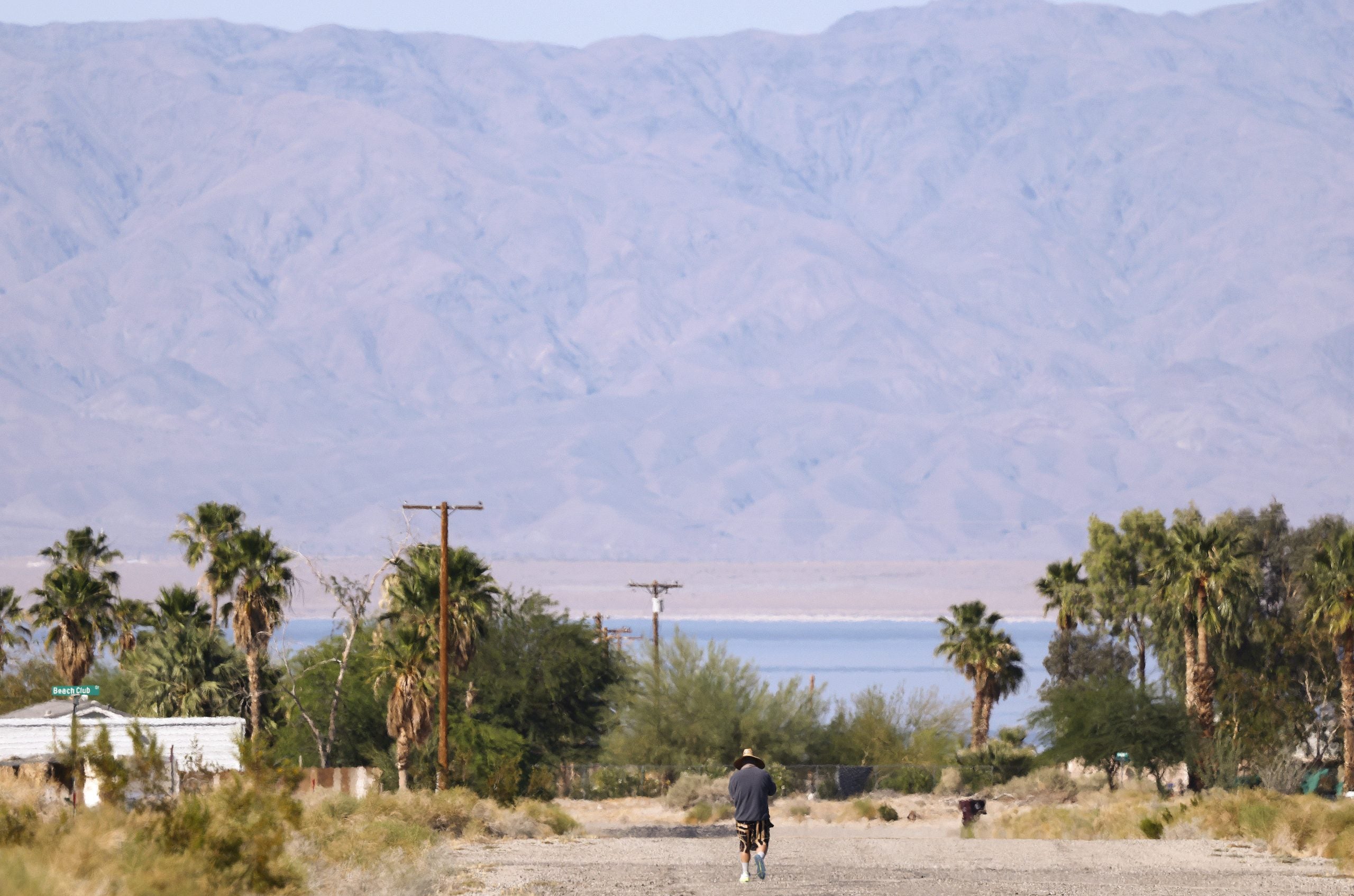 SALTON CITY, CALIFORNIA - APRIL 30: A person walks with the Salton Sea in the distance on April 30, 2026 in Salton City, California. California has launched the Salton Sea Conservancy, its first new conservancy in more than 15 years, in an effort to support long-term habitat restoration while improving air quality around the deteriorating inland lake. The Salton Sea, located in the desert in Southern California, has been shrinking for decades and is now nearly twice as salty as the ocean while contaminated by pollutants including agricultural runoff. A deposit of geothermal brine beneath the Salton Sea is believed to hold one of the planet’s largest reserves of lithium and is worth an estimated $500 billion. The lithium could bring jobs to the region and help power electric vehicles, smartphones, and electricity grids while some residents are concerned that lithium extraction could exacerbate environmental issues. In 2022, Governor Gavin Newsom has called the area "the Saudi Arabia of lithium".