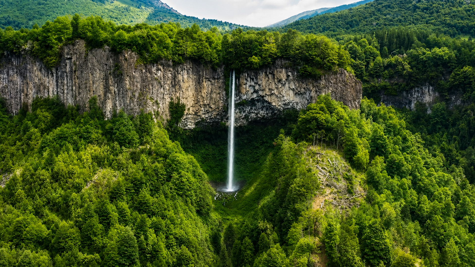 A waterfall falling from a wall of stone