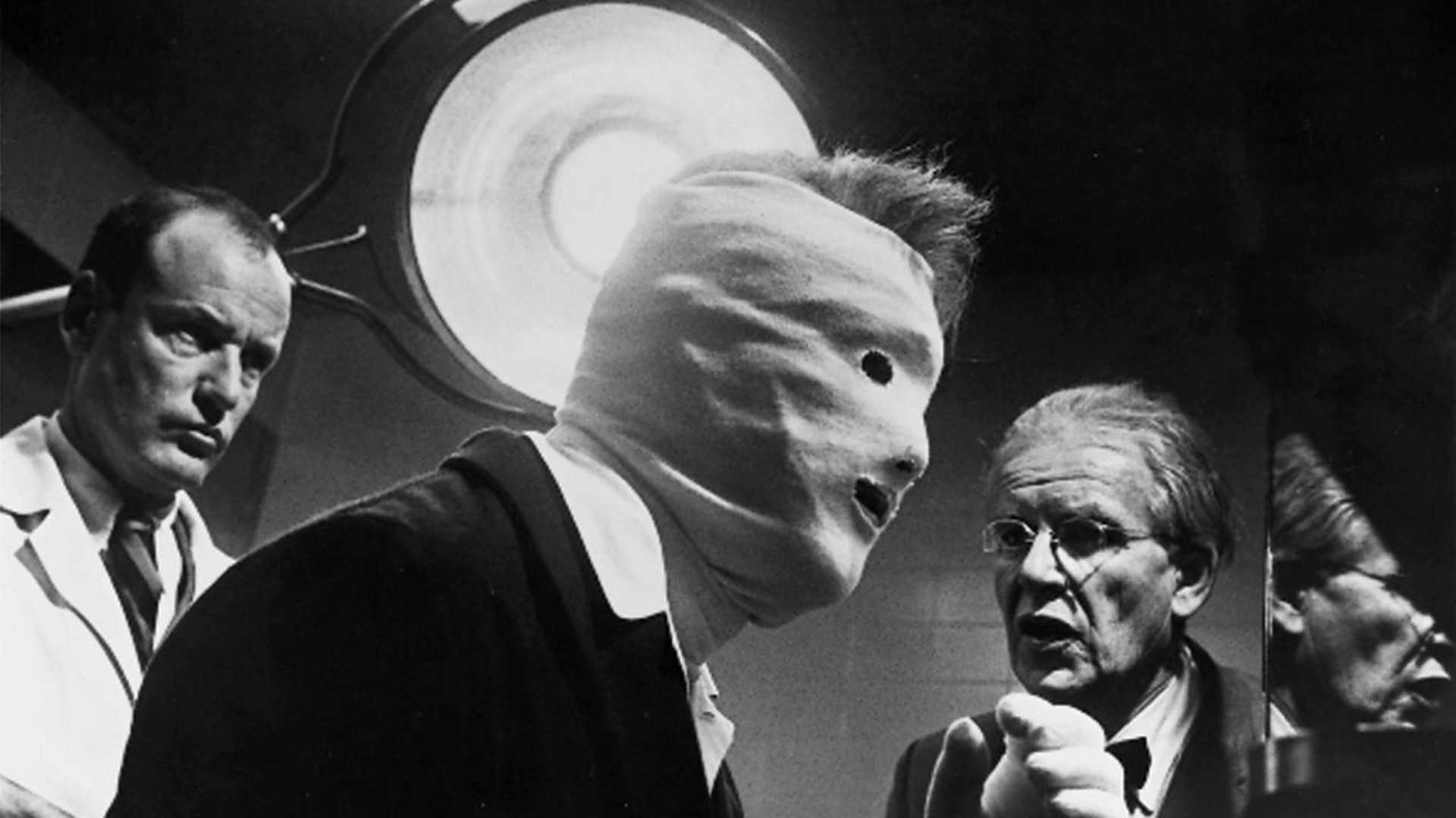 A man with bandages on his face talks to doctors in Seconds