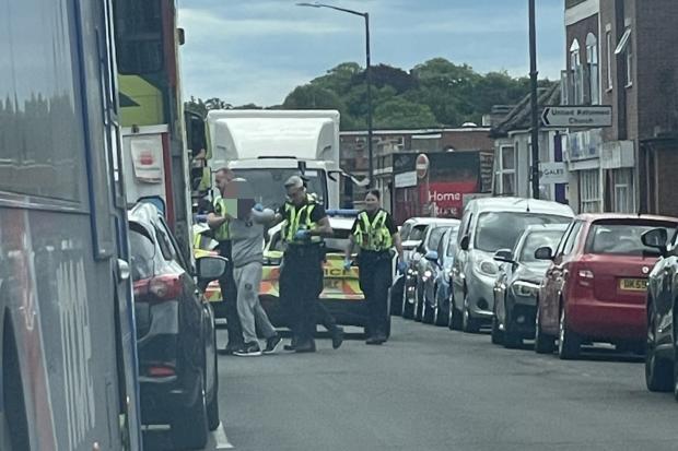 Man arrested after reportedly lying in road and assaulting police officer