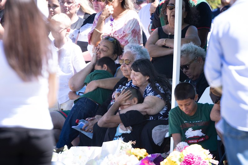 Sophie’s mother Cathy Quinn, holding a boy at the funeral in March. Sophie’s grandmother Bev also looks on (centre, black and white shirt).