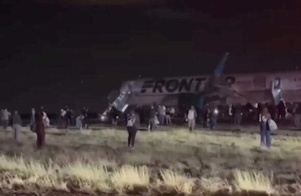 Passengers evacuating the Frontier Airlines plane after the strike