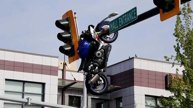 Video shows motorcycle hanging from traffic light after crash in Canada