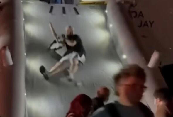 Passengers evacuating down slide from plane