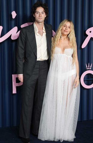 Oli Green and Sienna Miller in December 2025 Credit: Lucy North/PA Images via Getty