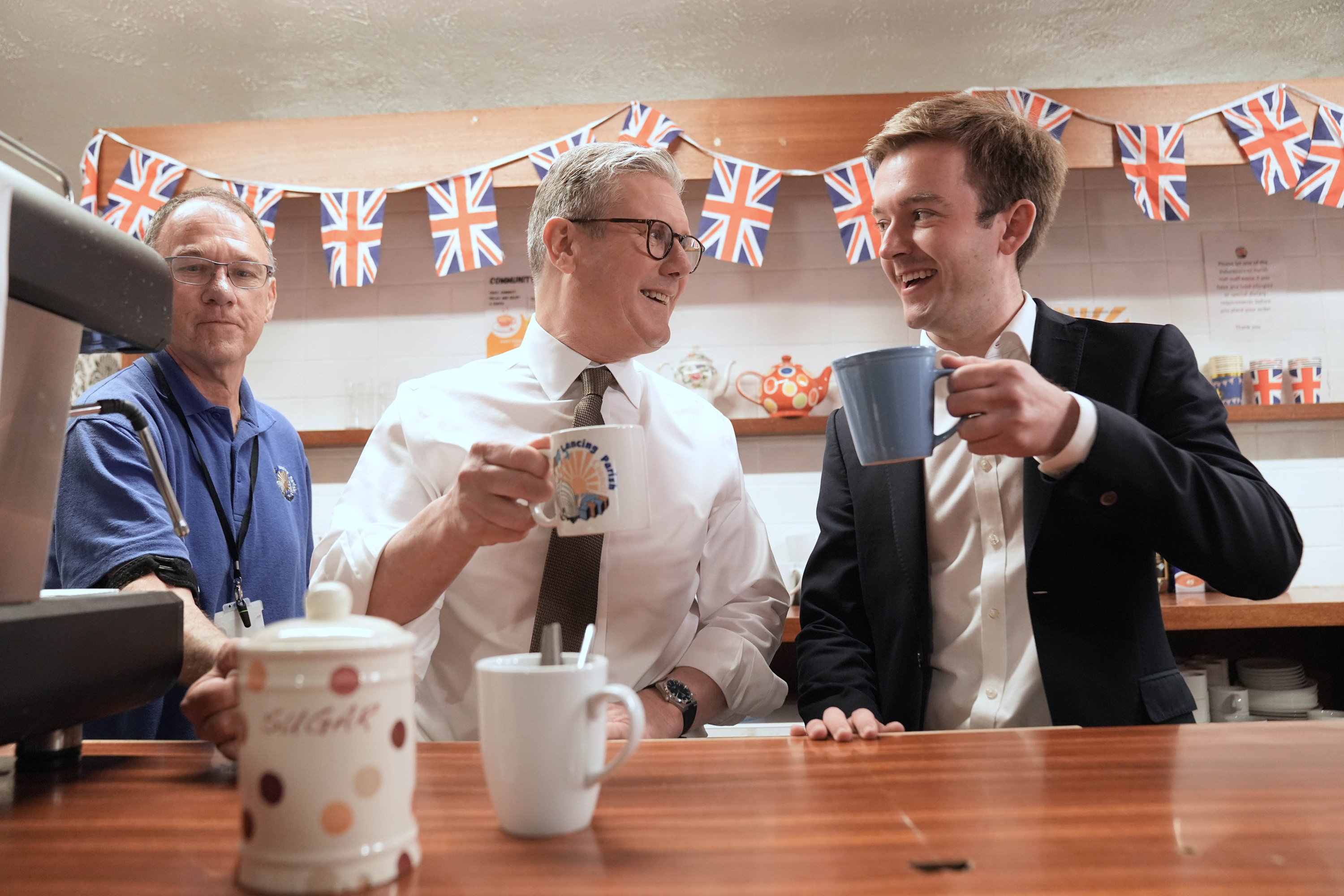 Sir Keir Starmer has a drink with Labour candidate, now MP, Tom Rutland on the campaign trail in 2024 (Stefan Rousseau/PA) (PA Archive)