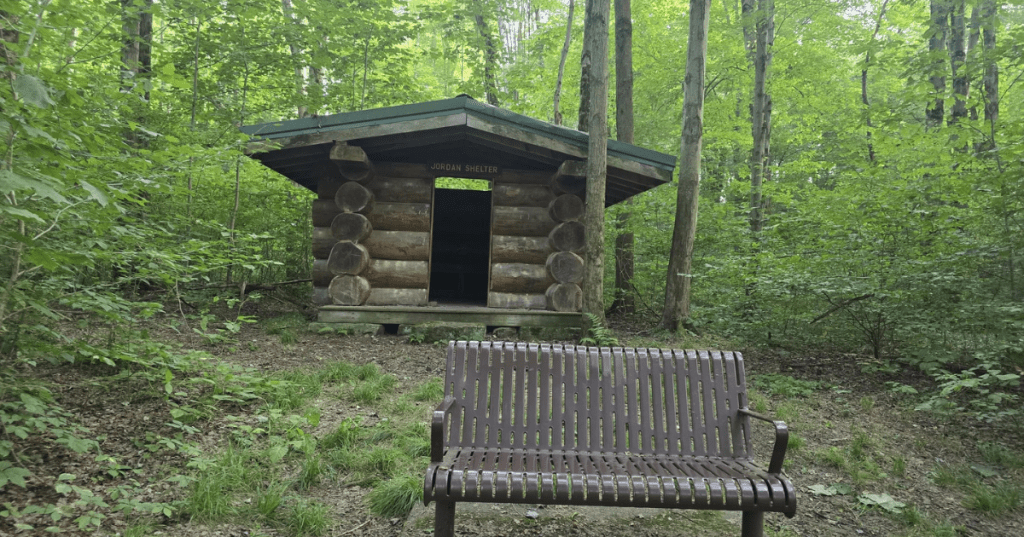 A small log cabin-like shelter labeled