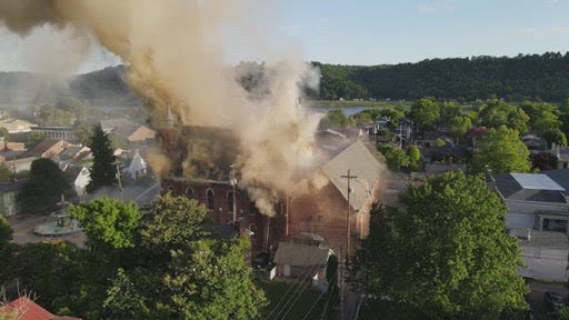 Drone aerials of historic church on fire in Madison, Indiana