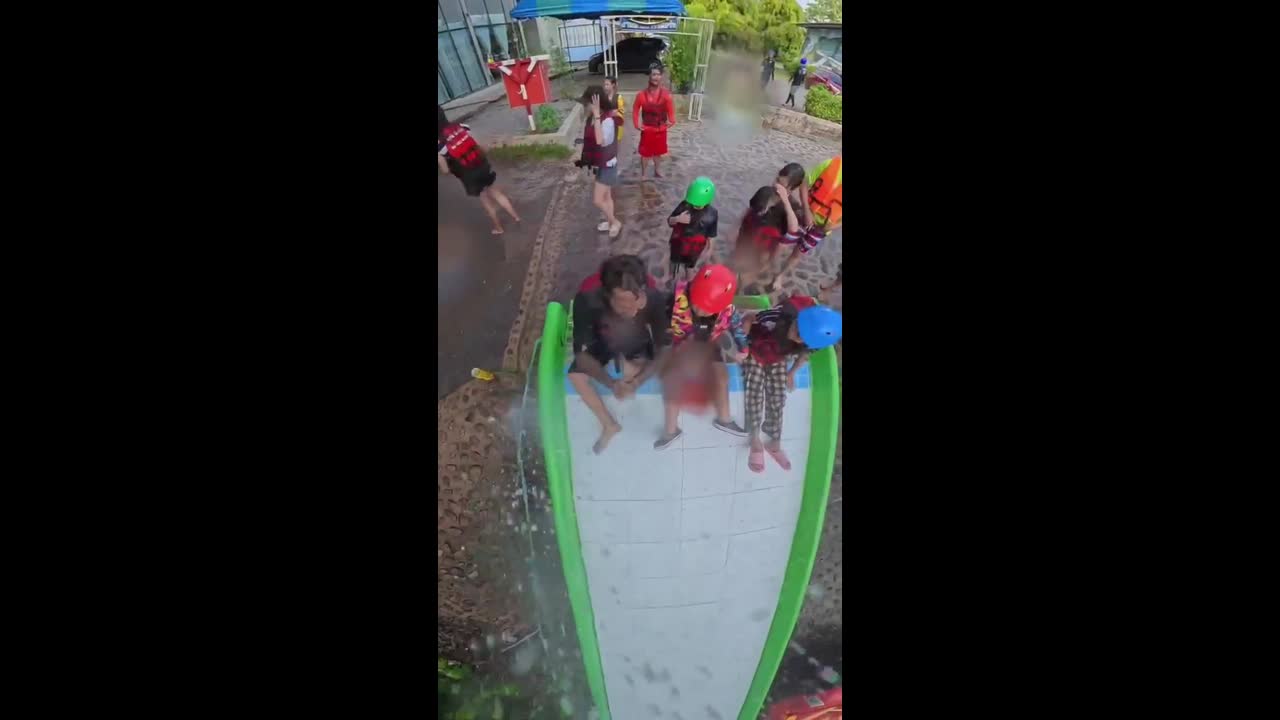 Tourists land on raft with perfectly timed slide into river