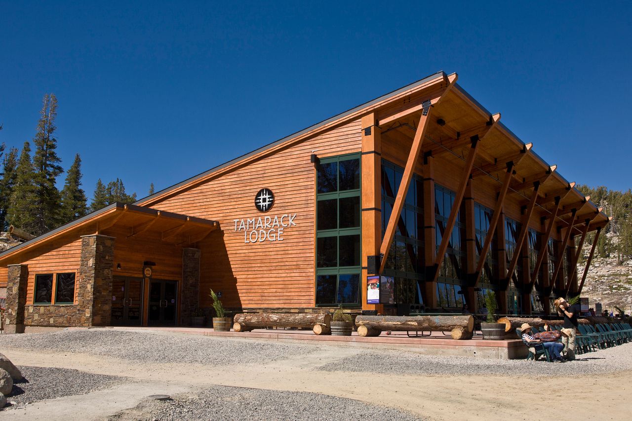 Building with a sign reading Tamarack Lodge in a mountainous area