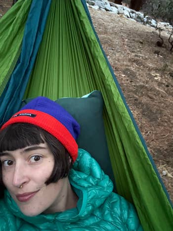 Person relaxing in a hammock outdoors