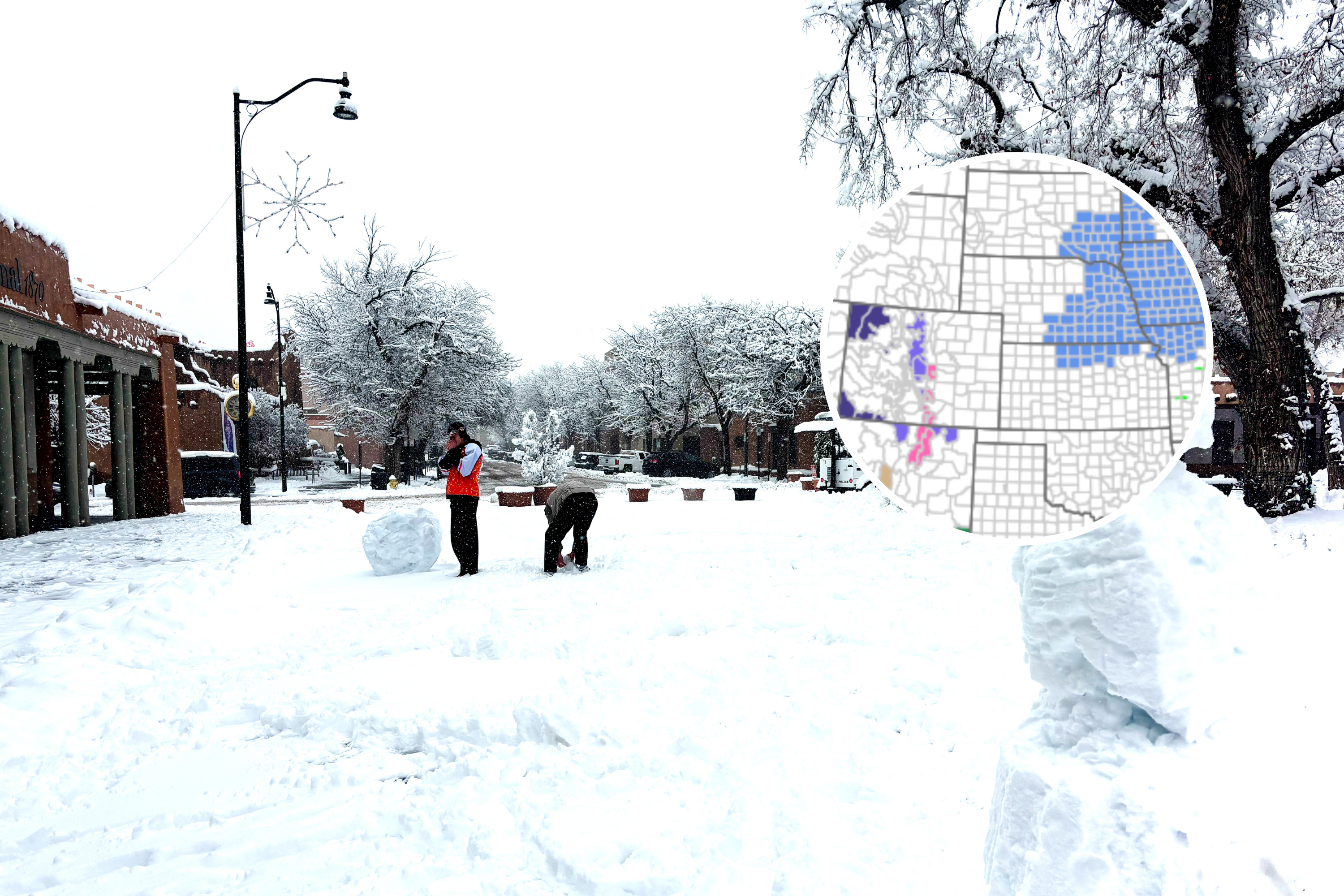 Stock image: Santa Fe, NM: Two young men making snowmen on the historic Santa Fe Plaza after a snowstorm – undated
