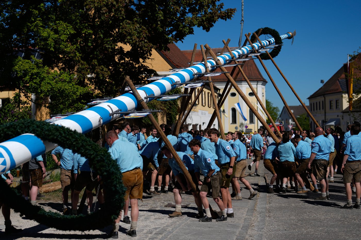 Beer, music and shouts of 'Hau-Ruck' as a Bavarian village raises its ...