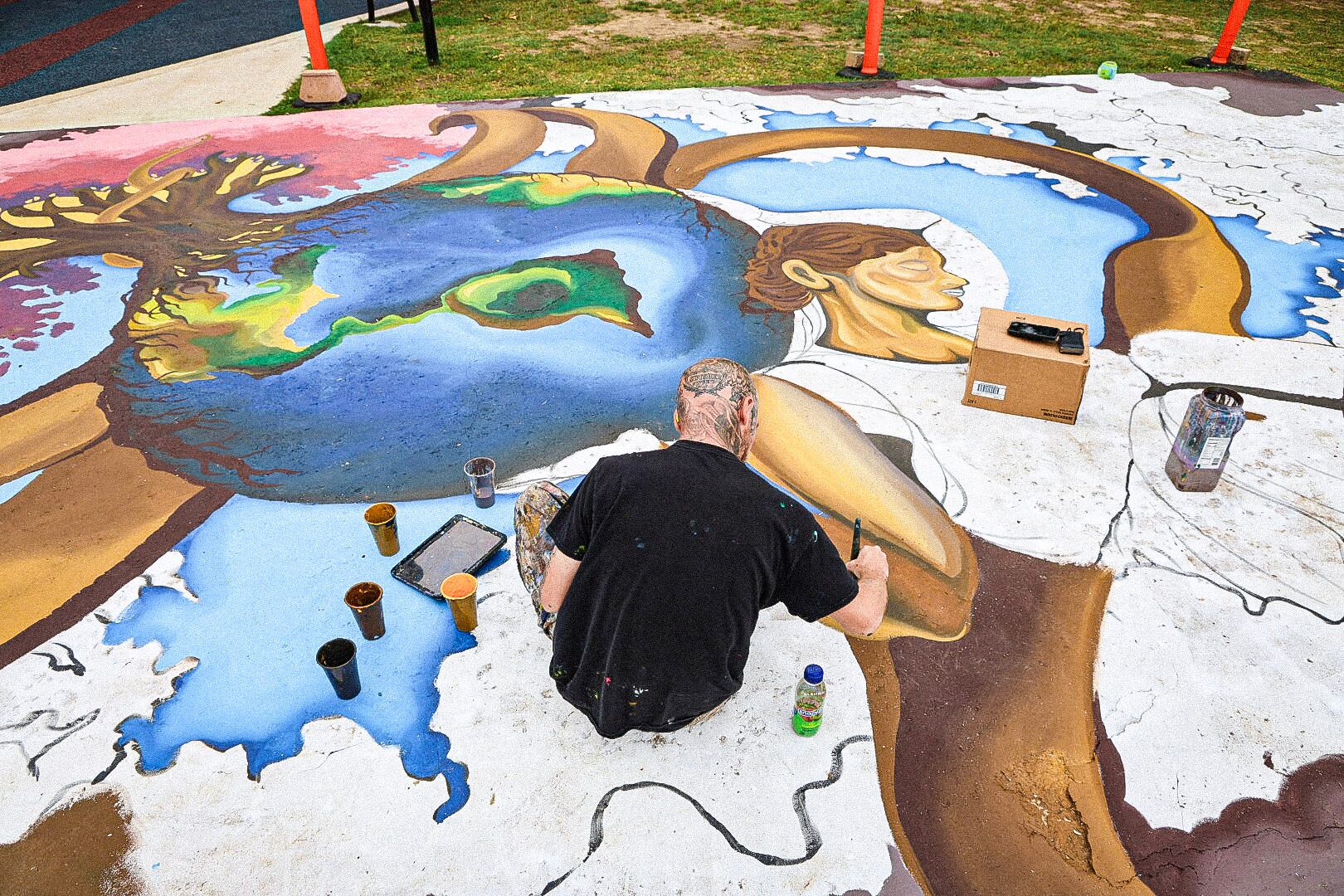 Artist creates Earth Day mural at Durant’s Rocket Park