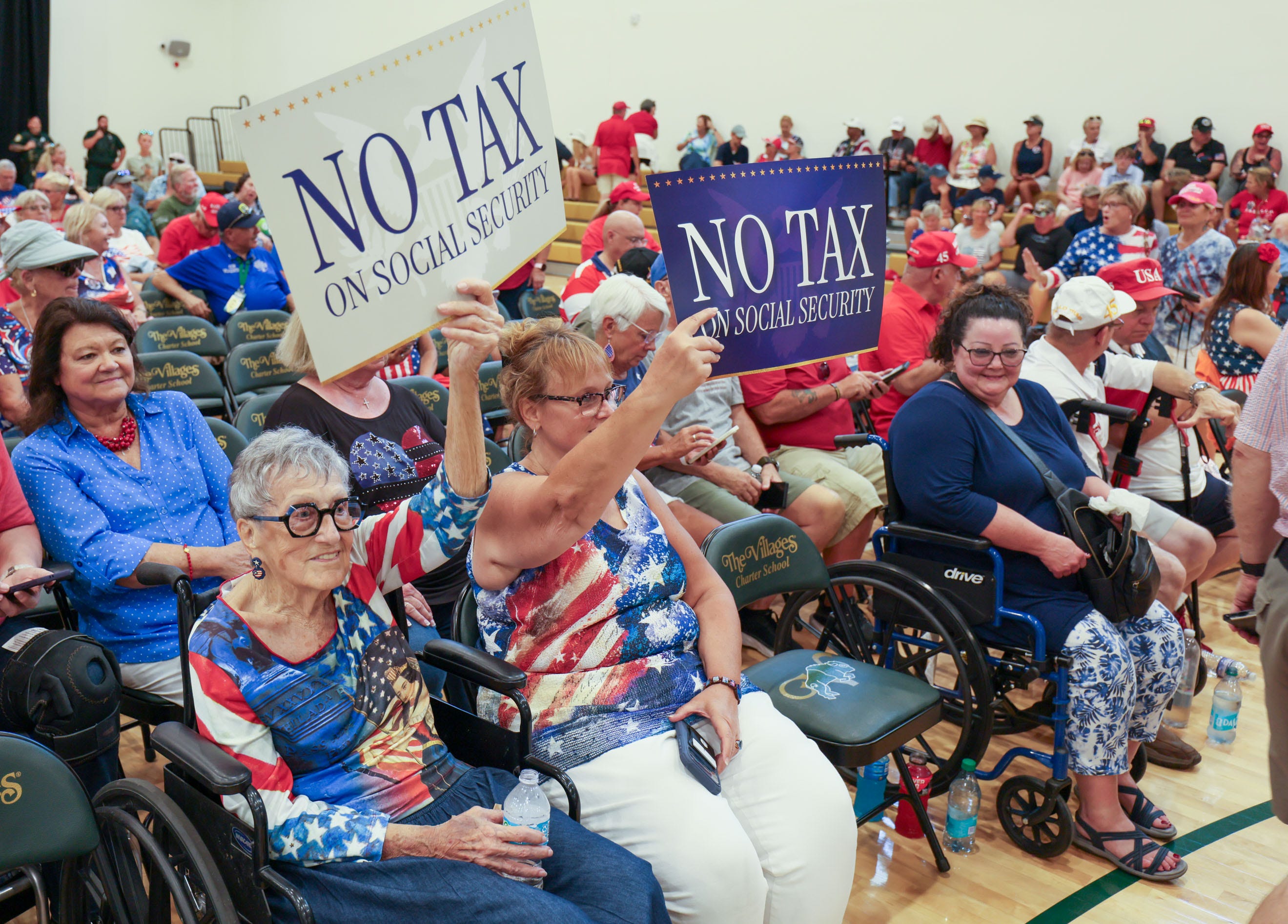 Supporters hold signs before President Donald Trump speaks at Middleton High School (The Villages Charter School) on May 1, 2026, in The Villages.