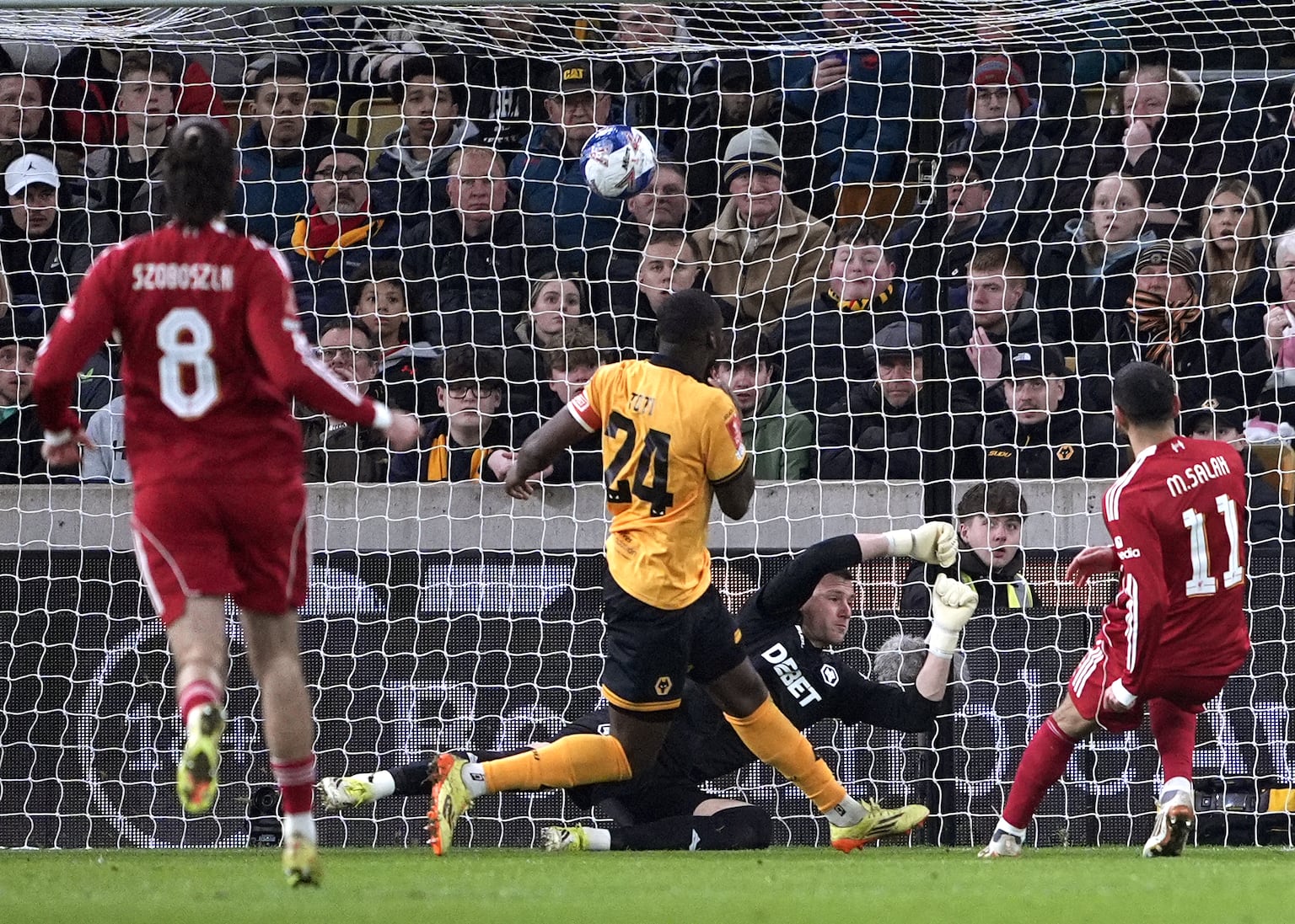 Mohamed Salah, right, scores against Wolves