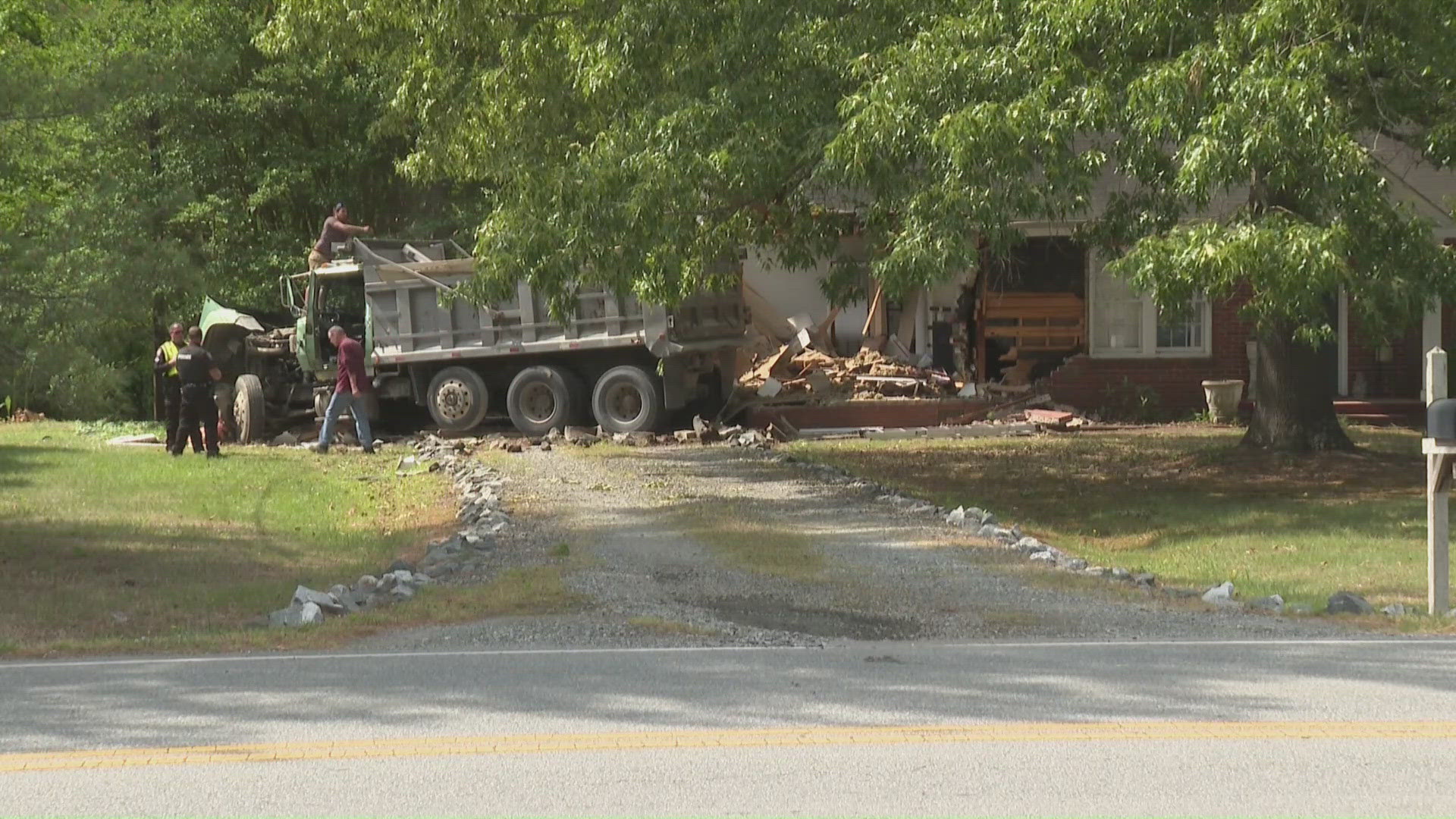 Dump truck crashes into Greensboro home on Vandalia Road