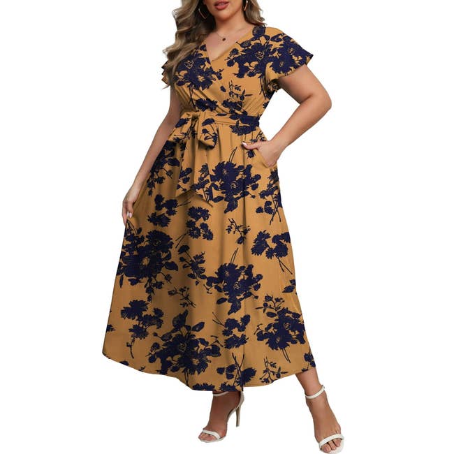 Person in floral print dress with a belted waist and short sleeves