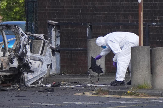 Forensic investigators at the scene in Dunmurry (Niall Carson/PA) (PA Wire)