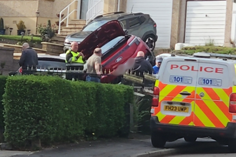 Car flips on its side in horror Glasgow crash as police rush to scene