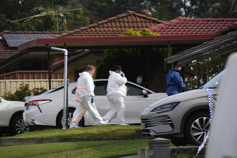 Police at the house in Rosemeadow, where three people died in an attack on Sunday morning.
