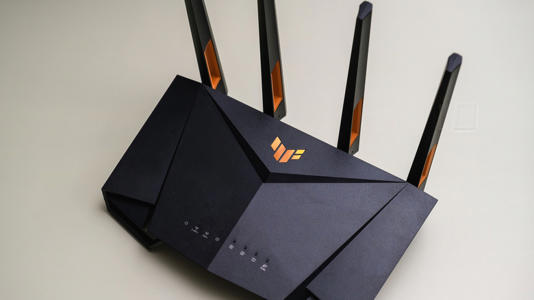 The ASUS TUF Gaming AX4200 gaming router on a beige surface