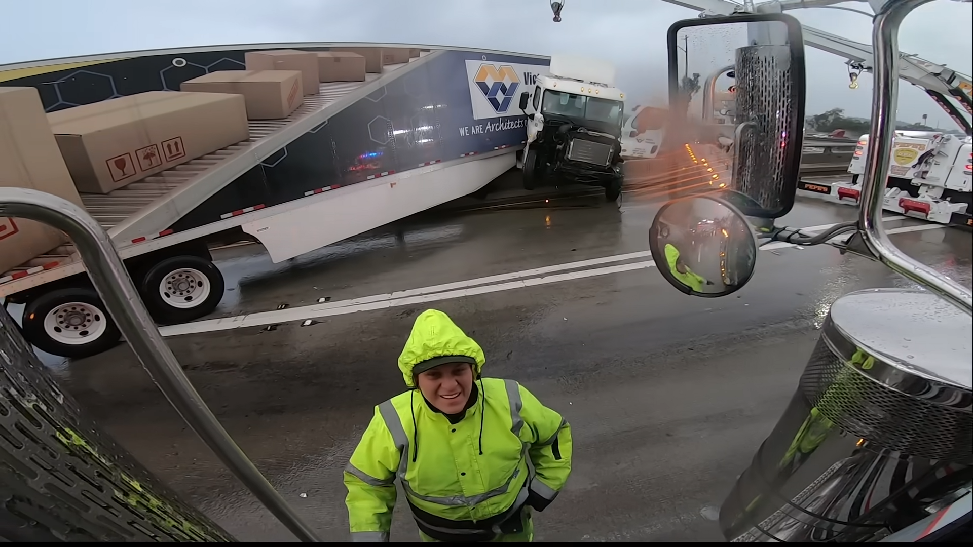 Big rig crashes and ends up hanging off a freeway bridge