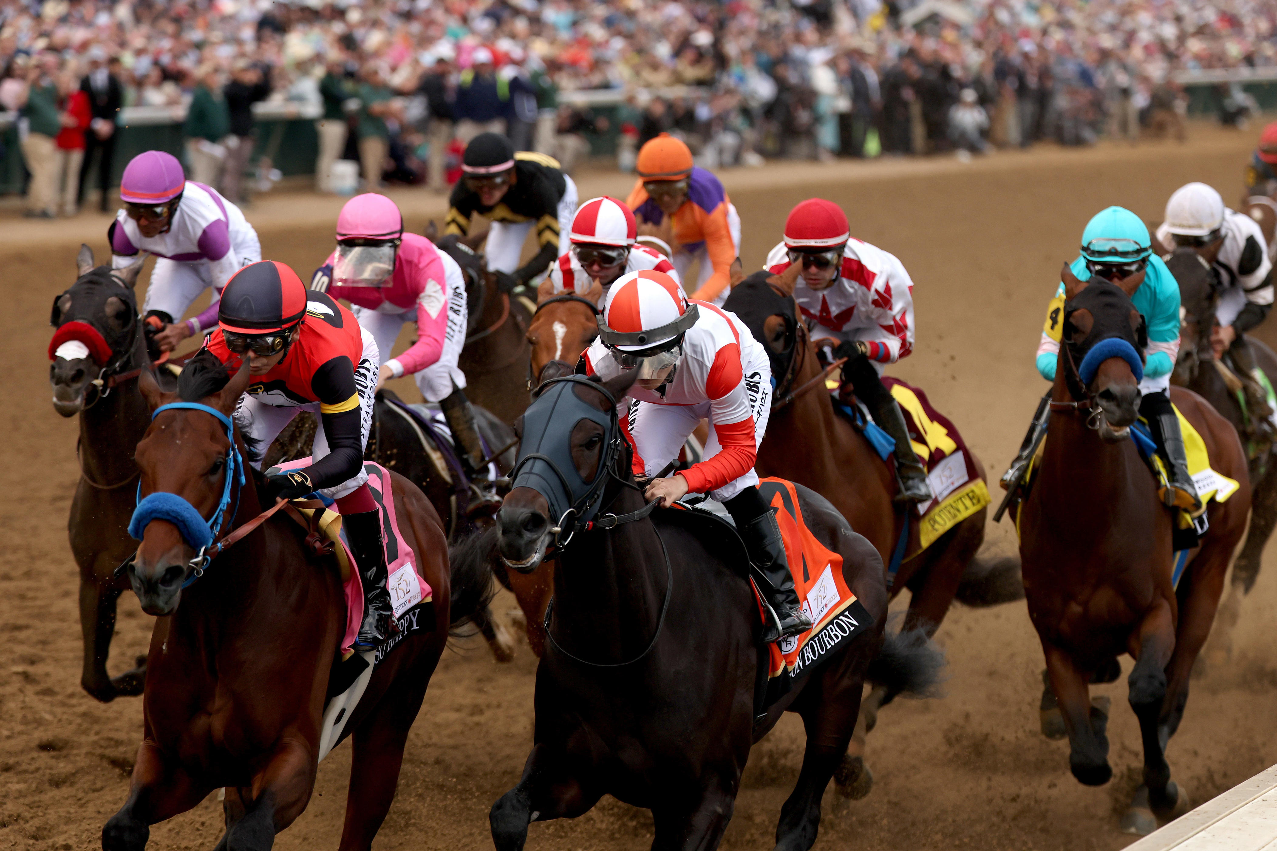 So Happy (front left), ridden by jockey Mike Smith, and Danon Bourbon (front right), ridden by jockey Atsuya Nishimura, lead the field during the 152nd running of the Kentucky Derby at Churchill Downs.