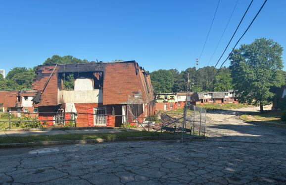 Portion of roof collapses as fire rips through apartment building