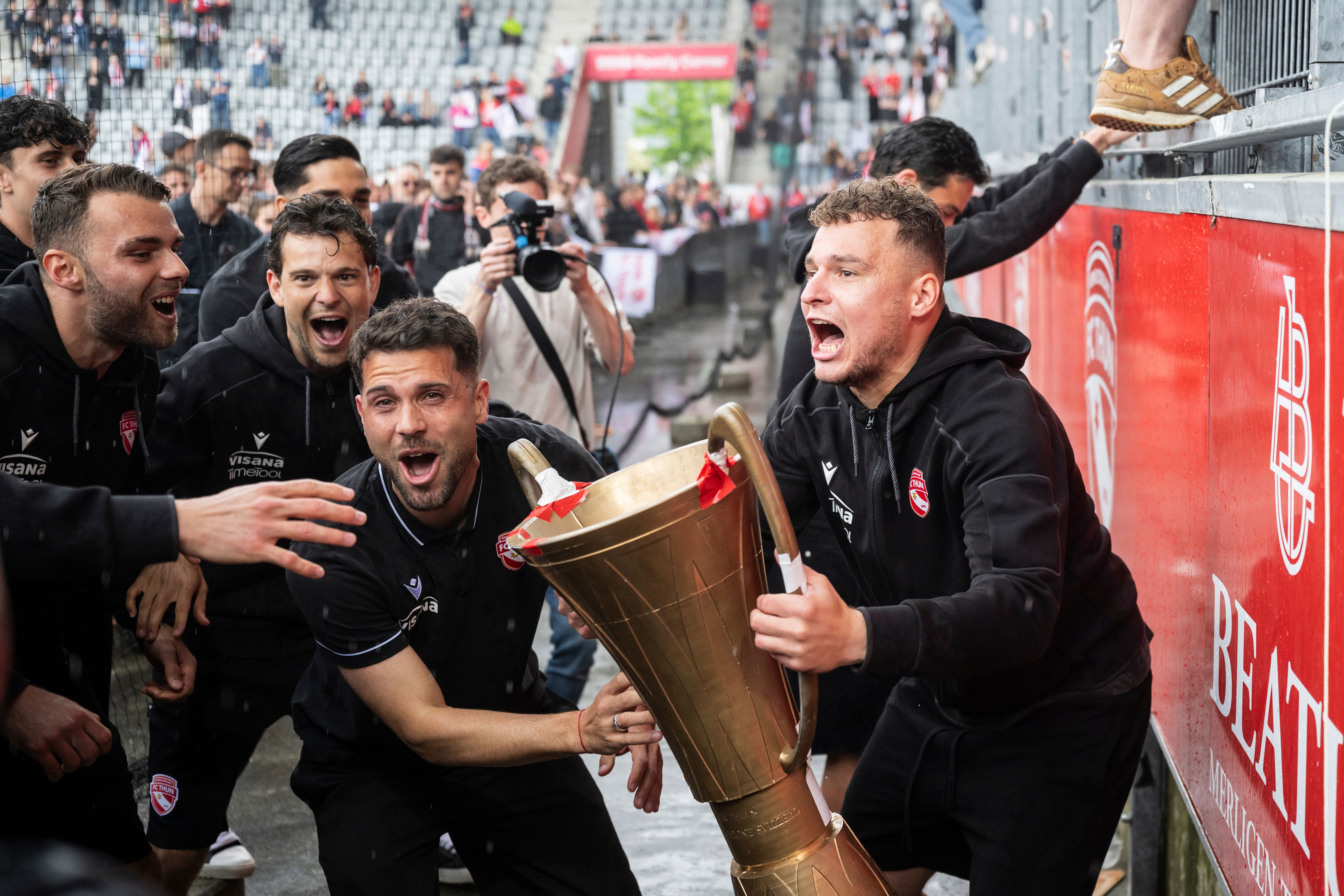 Thun's Vasilije Janjicic, right, and Leonardo Bertone, lift a dummy trophy to celebrate the championship title in Thun, Switzerland, Sunday, May 3, 2026. (Alessandro della Valle/Keystone via AP)