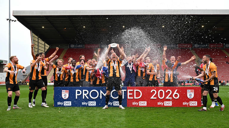 Captain Michael Morrison celebrated with his Cambridge team-mates after sealing promotion to League One