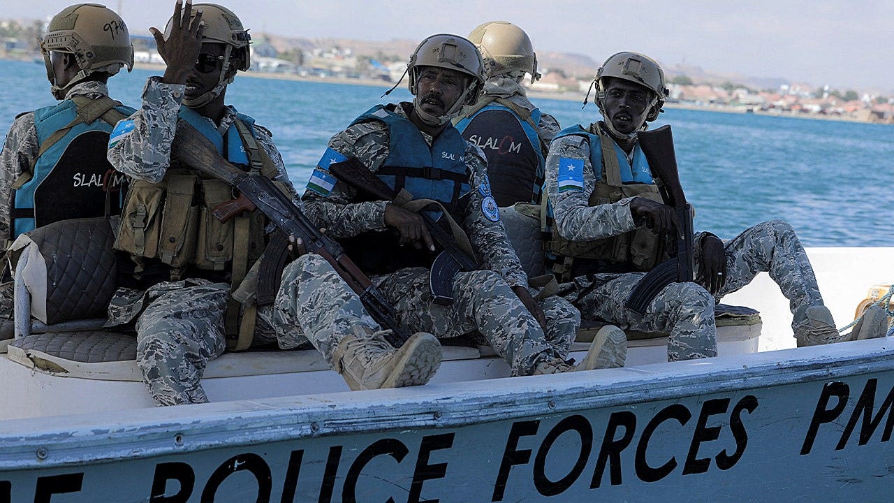 Members of the Puntland Maritime Police Force (PMPF) sit on a speed boat as they patrol the Gulf of Aden waters off the coast of Bosaso in the semi-autonomous region of Puntland, Somalia.