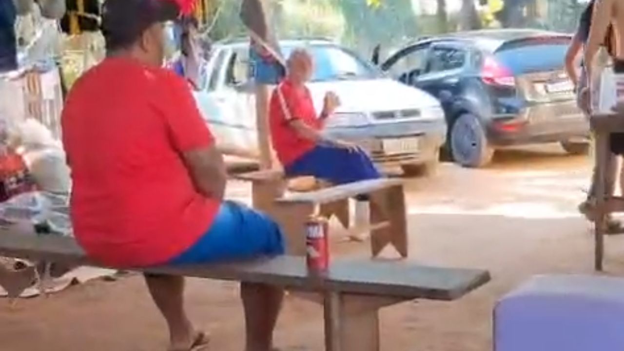 Man gets scared by a loud bang and topples off bench