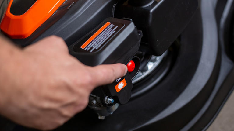 What does the red button on your lawn mower do?