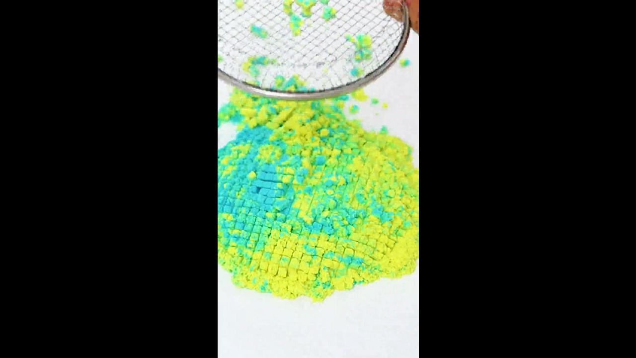 Satisfying pressing blue and yellow sand tower with mesh strainer ...