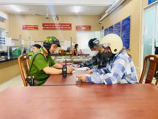 Hai người xả rác bừa bãi trên đường Nguyễn Văn Linh bị công an phường mời làm việc - Ảnh: Công an phường Tân Mỹ