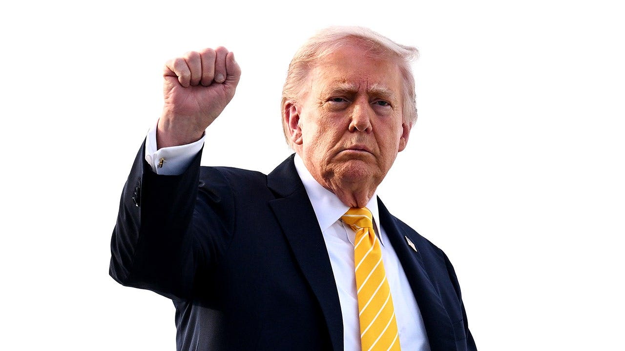 President Trump raises a fist as he departs Doral, Florida en route to his Palm Beach mansion on May 2, 2026 in Palm Beach, Fla.