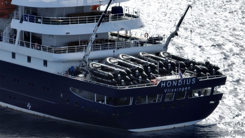 This aerial picture shows a general view of the cruise ship MV Hondius stationary off the port of Praia, the capital of Cape Verde. - CNN