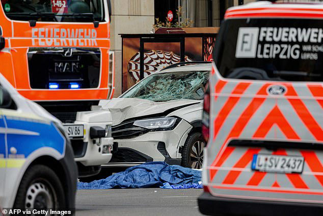 Woman and man are dead and 20 are hurt after car ploughs into crowd in ...