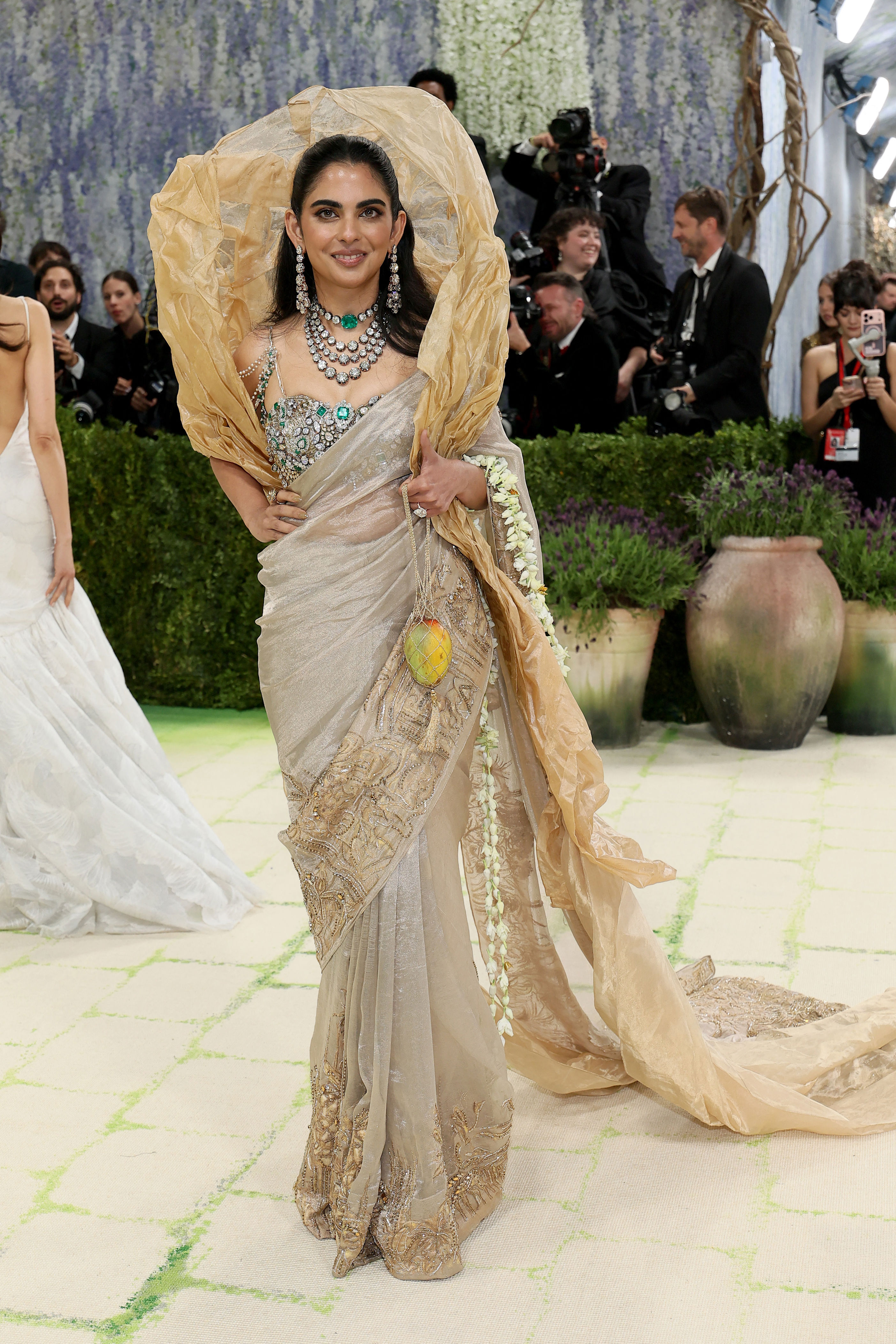 ambani gold dress Nita Ambani was a vision in a Manish Malhotra antique gold ensemble at  Anant and Radhika's mehendi ceremony. On Instagram, the designer revealed  that the outfit draws inspiration from the classic Hyderabadi