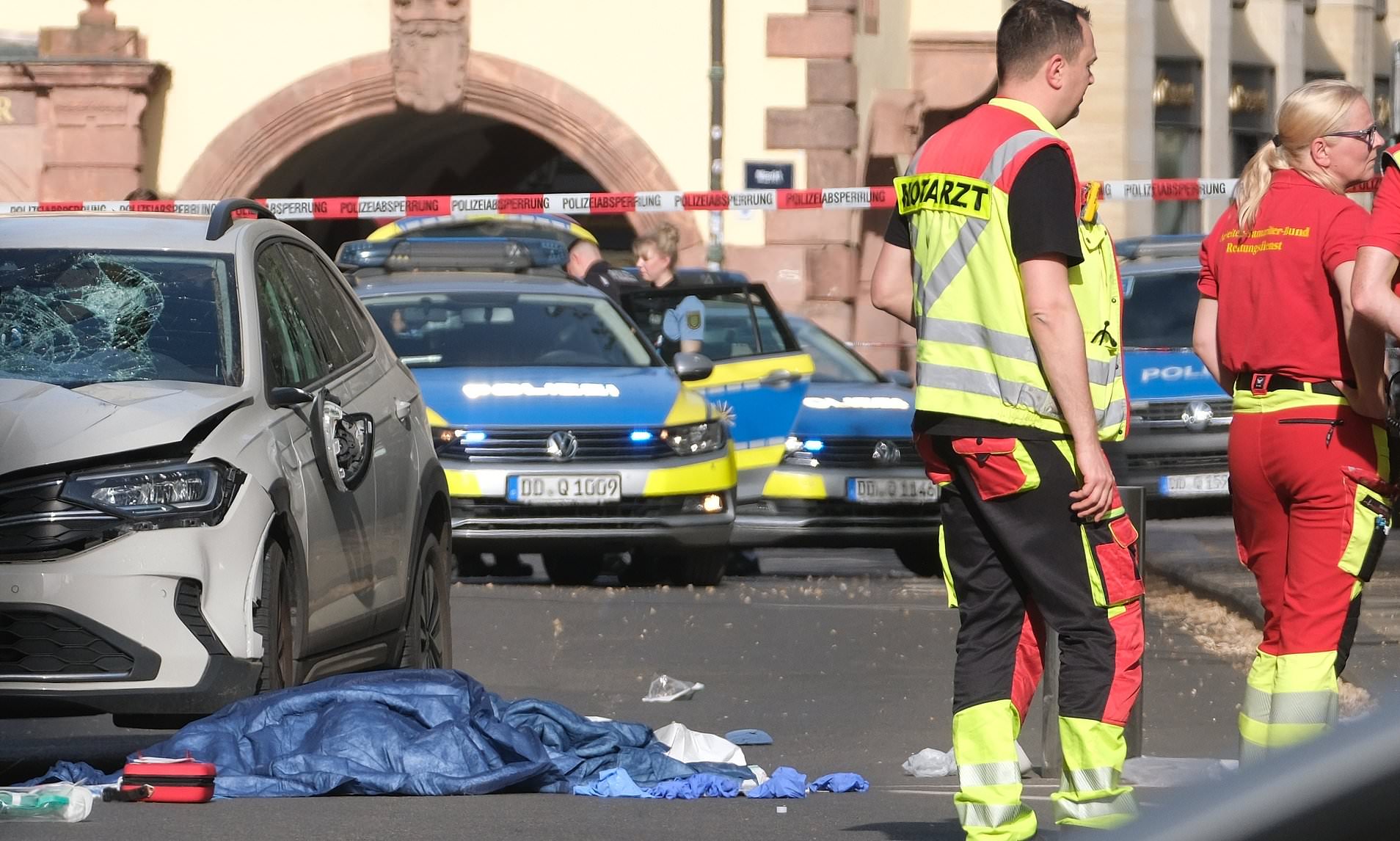 Two dead and more than 20 injured after car ploughs into crowd in ...