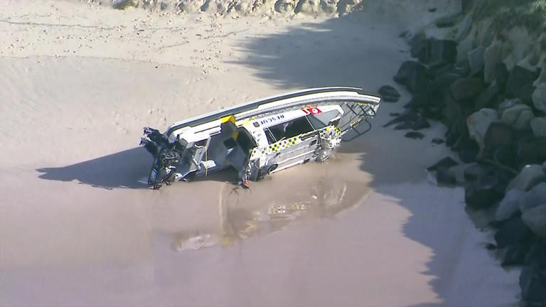 The NSW Marine Rescue boat washed ashore near the southern breakwall at Ballina. (ABC News)